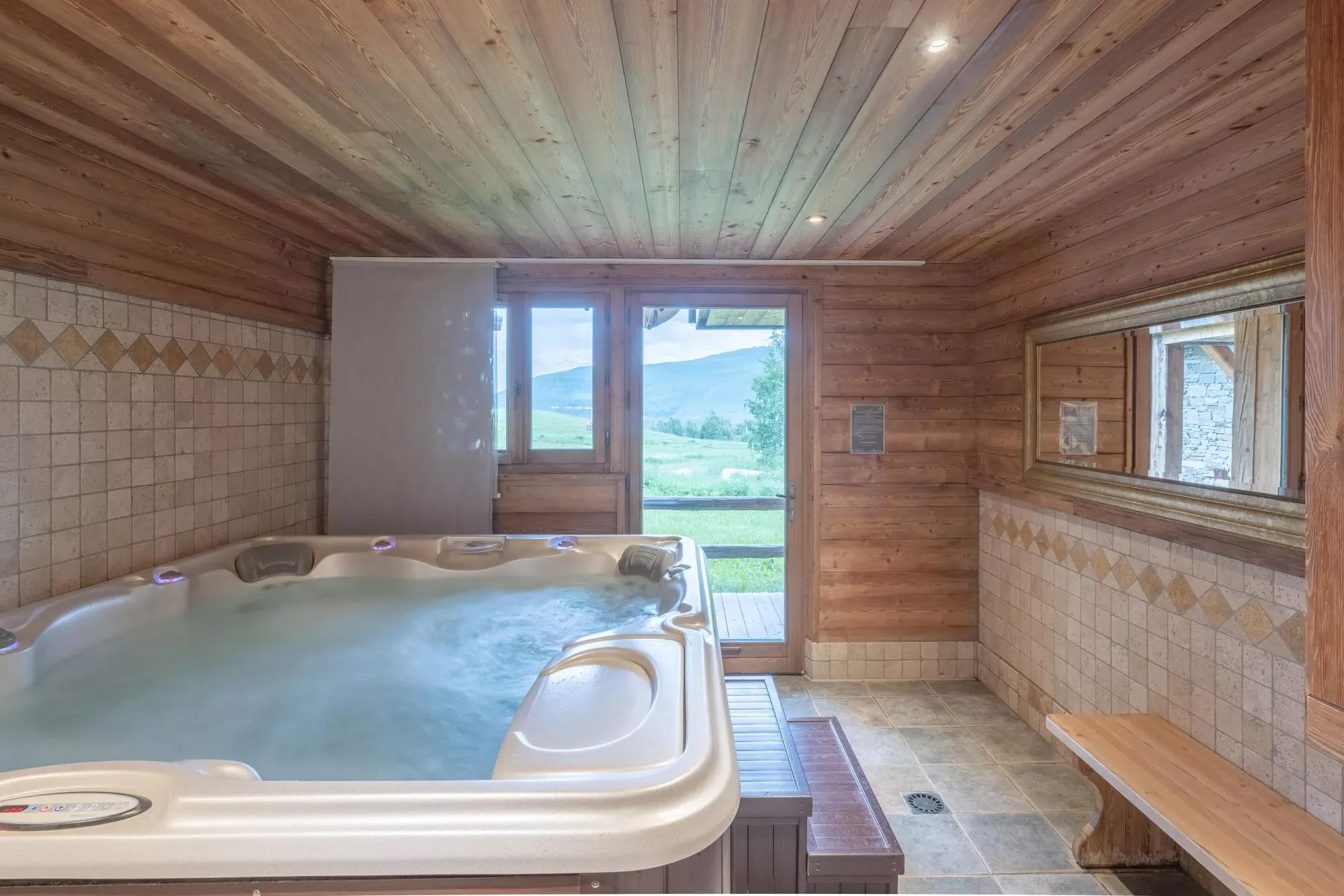 Indoor jacuzzi in the timber-lined wellness room