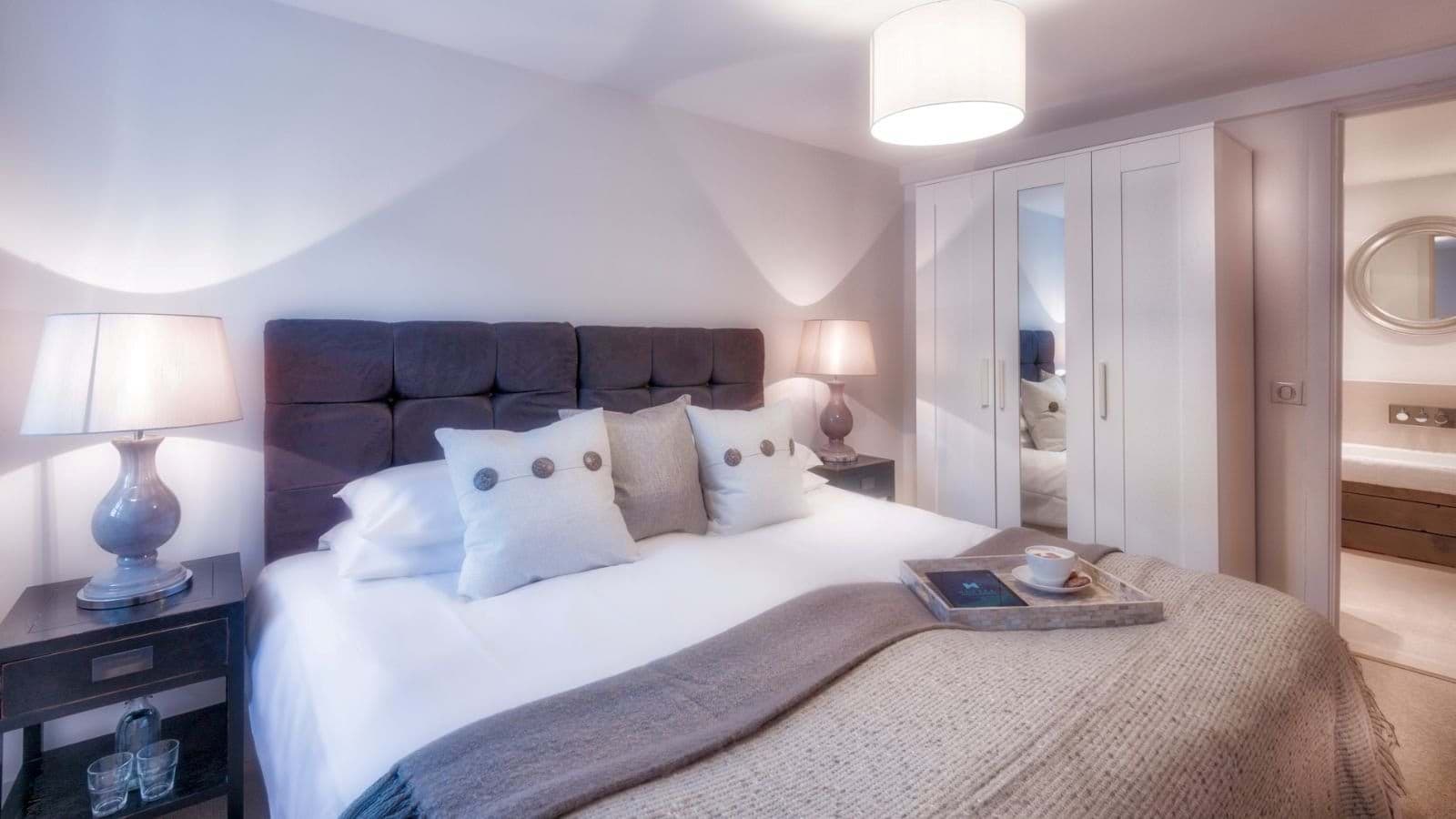 Primary bedroom with king bed and ensuite bathroom access