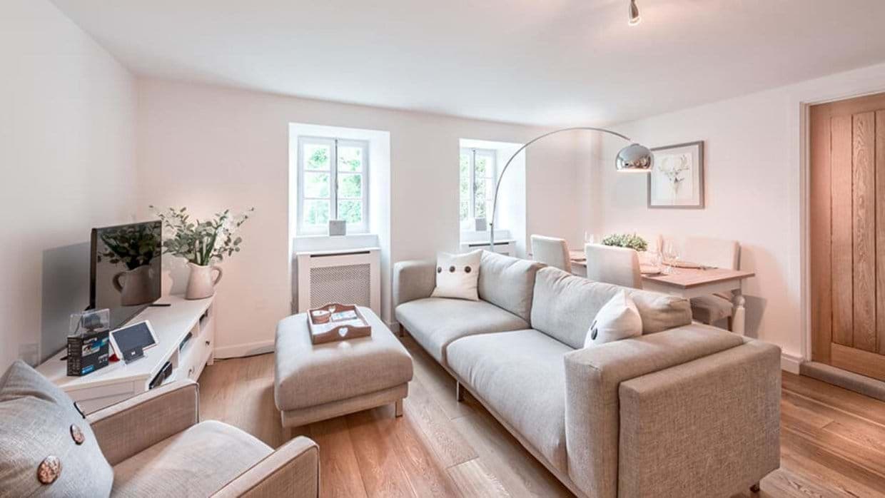 Open-plan living area with smart TV and dining seating for 4