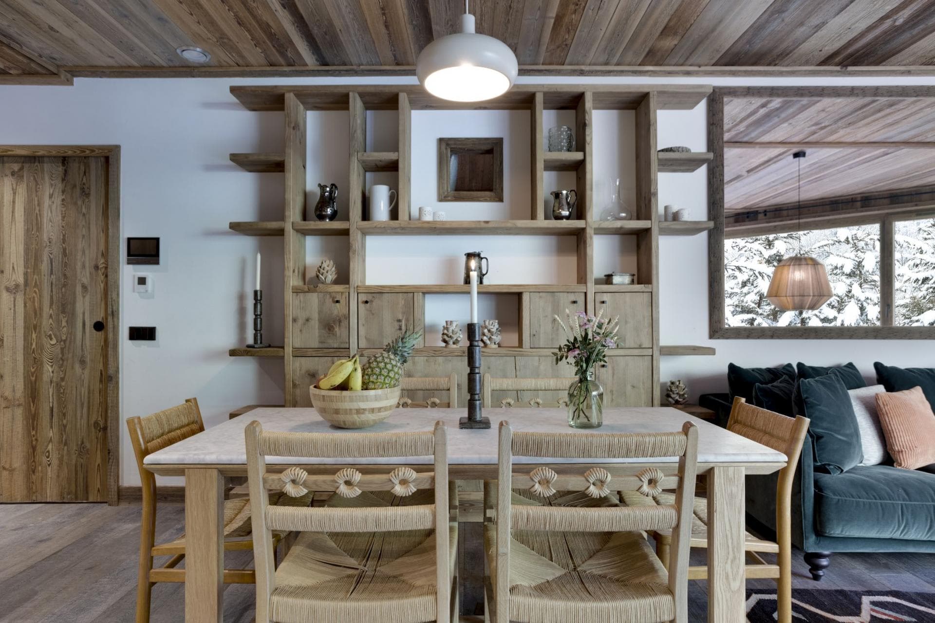 Dining area with seating for 6 and reclaimed wood shelving