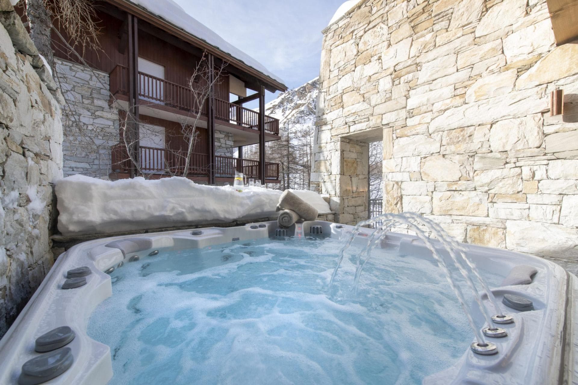 Outdoor hot tub with fountain jets and mountain views