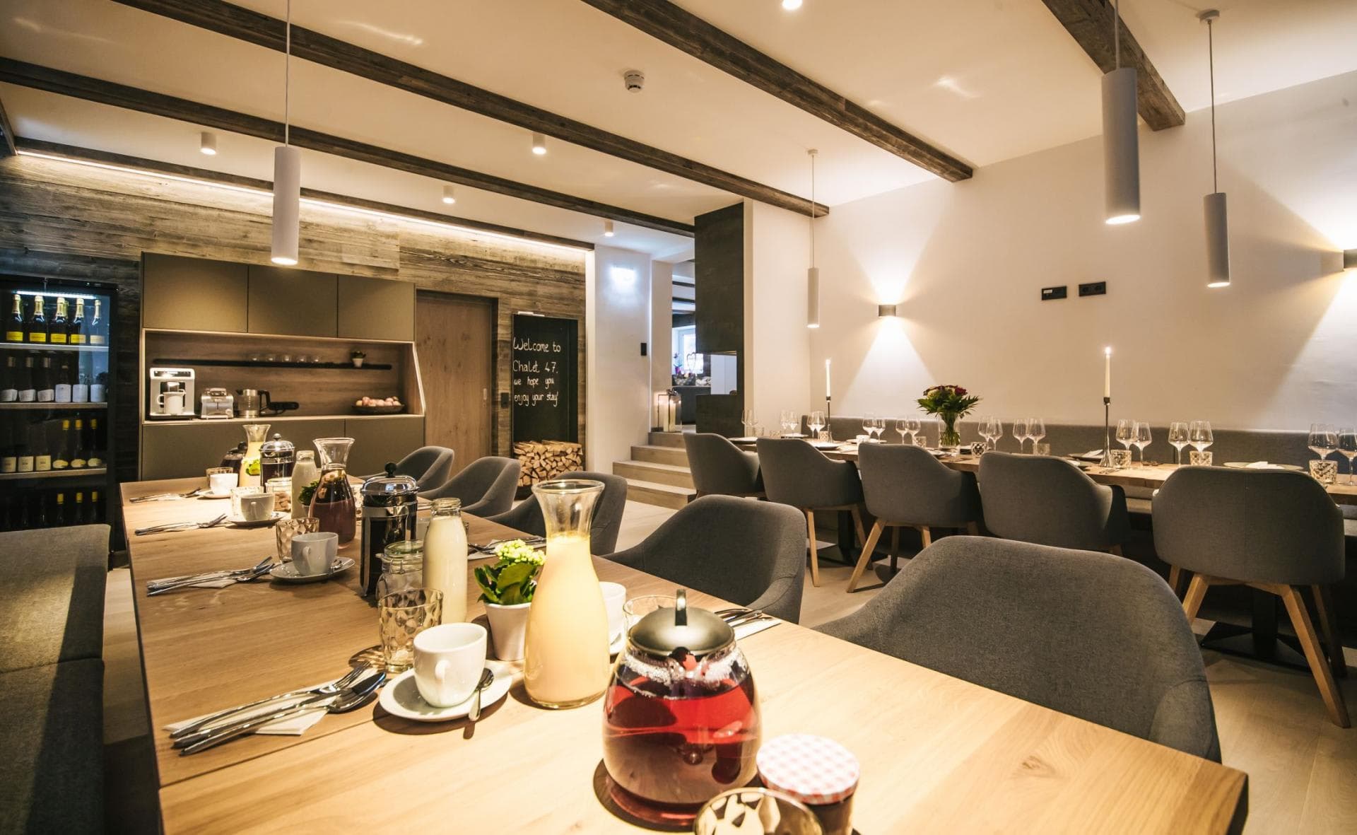 Dining space seats 8; open kitchen with wine display and wood-beam ceiling