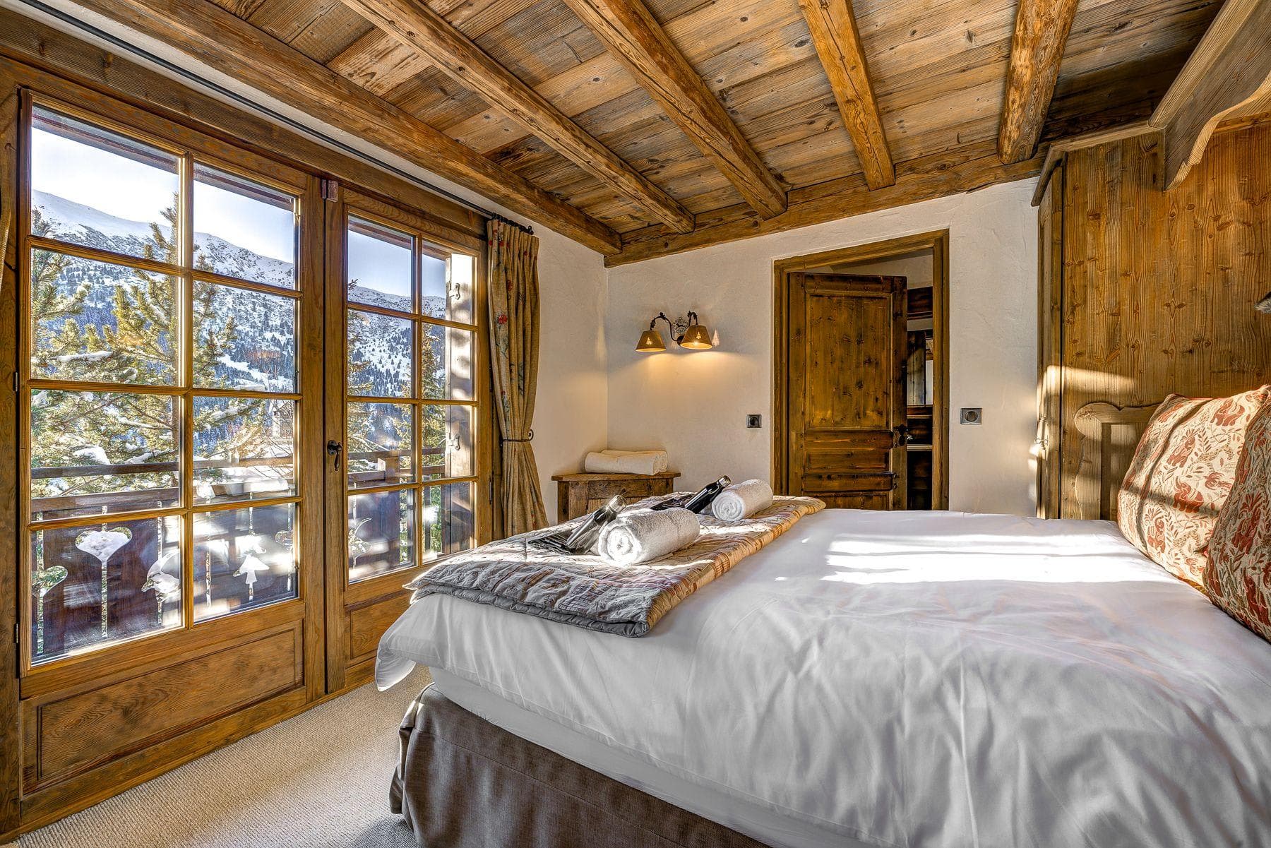 Bedroom with balcony access, mountain views, and ensuite bathroom