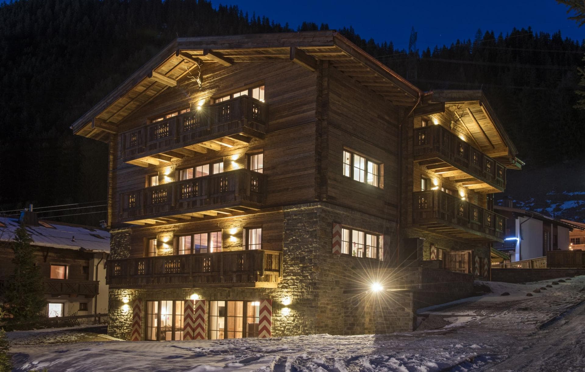 Multi-story chalet with stone ground floor and private balconies on every level