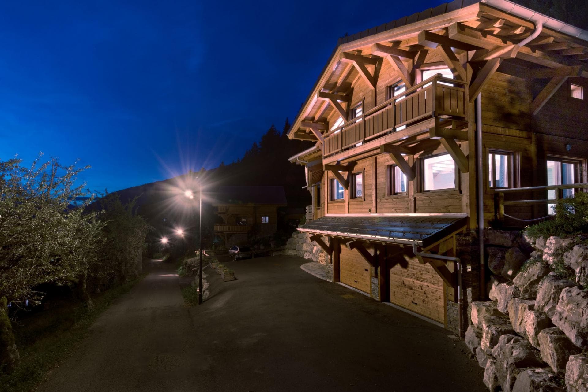 Chalet exterior with two-car garage and private balcony