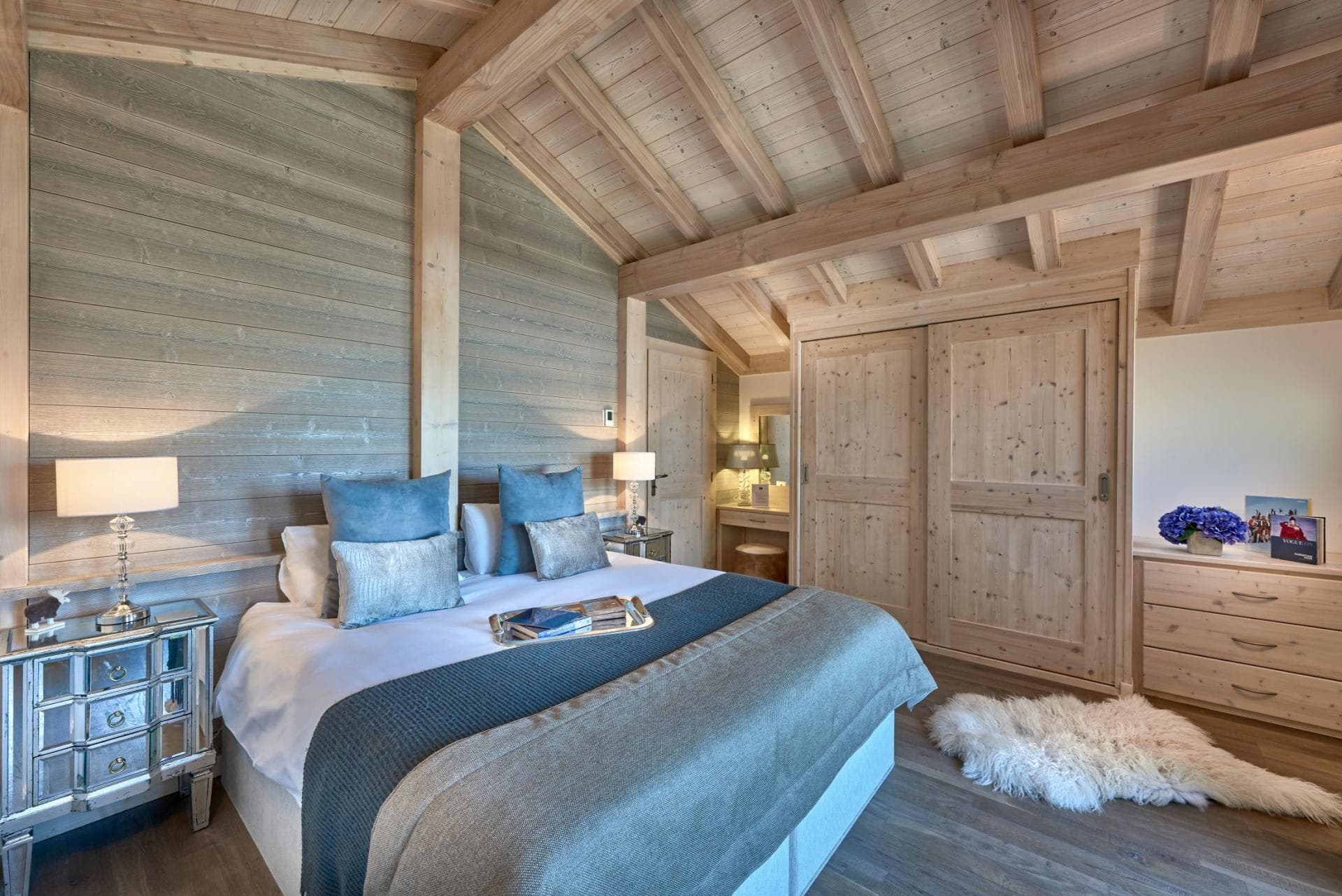 Bedroom with king bed, vaulted timber ceilings, and built-in closet storage