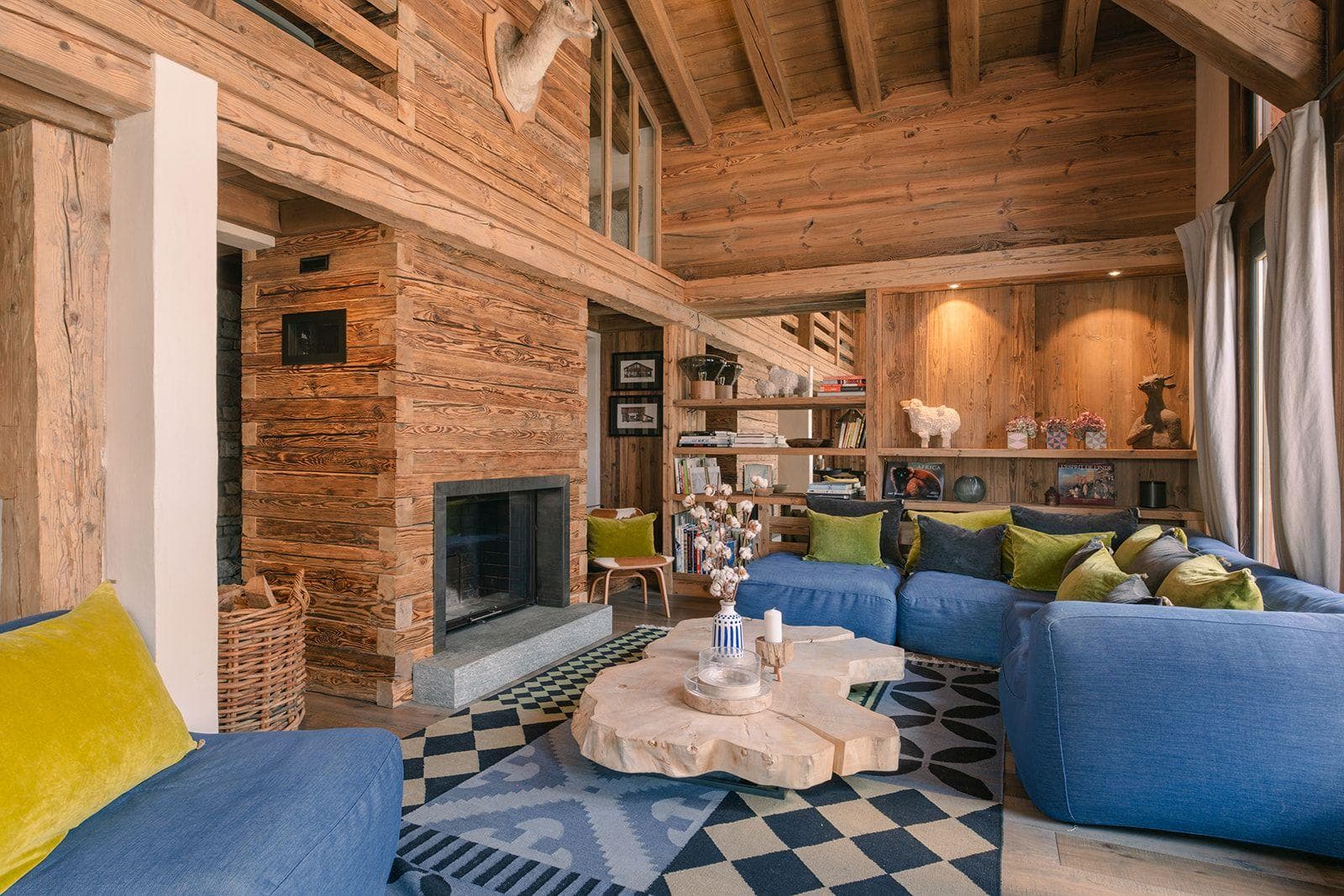 Living area with wood-burning fireplace and vaulted timber ceilings