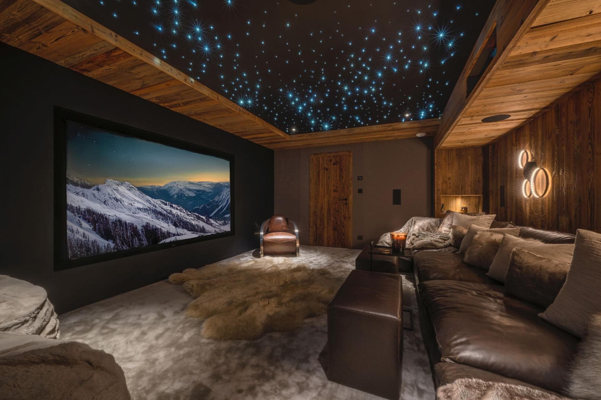 Cinema room featuring projector screen and fiber-optic starlight ceiling