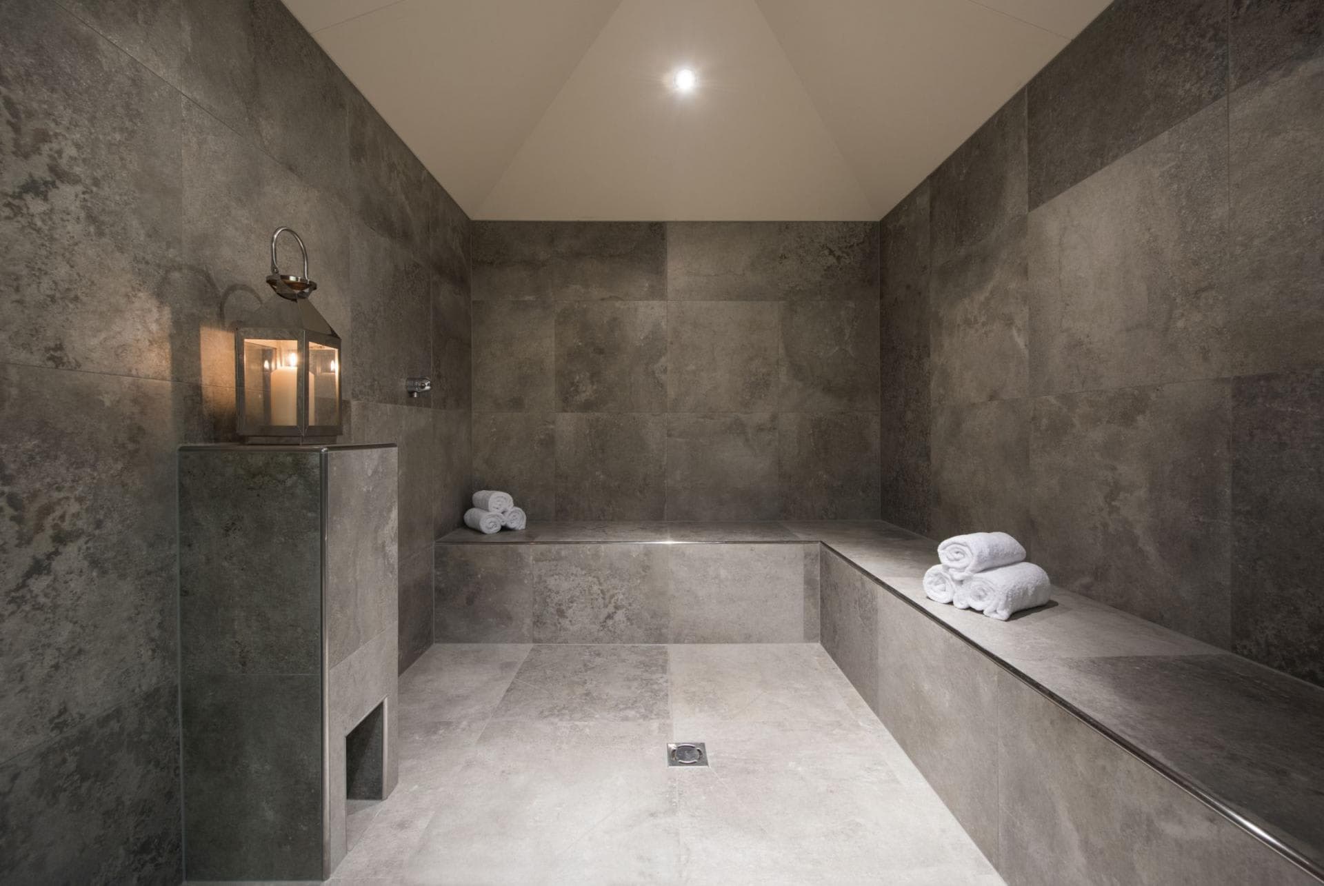 Private steam room with slate tiles and bench seating