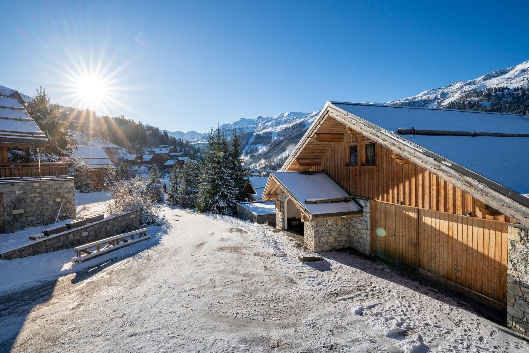 Chalet entrance and garage with direct mountain view and driveway access