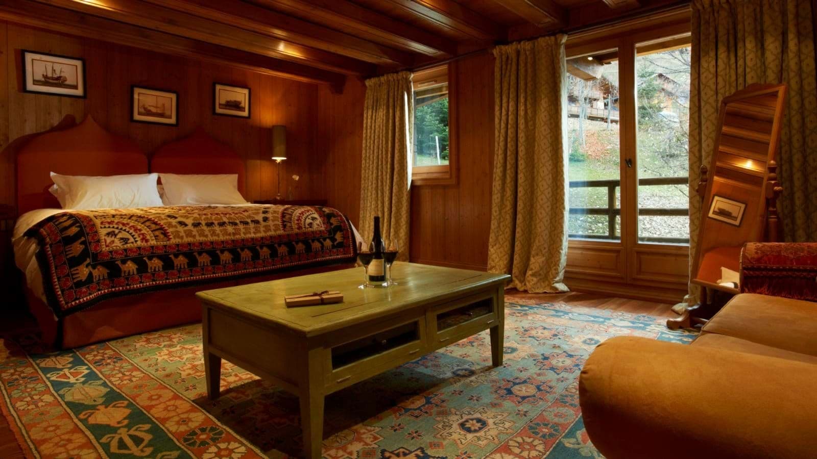 Guest suite with queen bed, seating area, and private balcony access