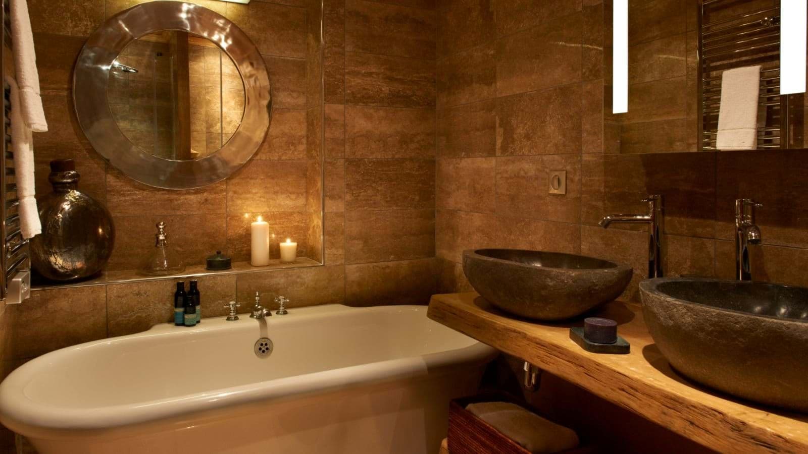 Bathroom with dual stone vessel sinks and soaking tub
