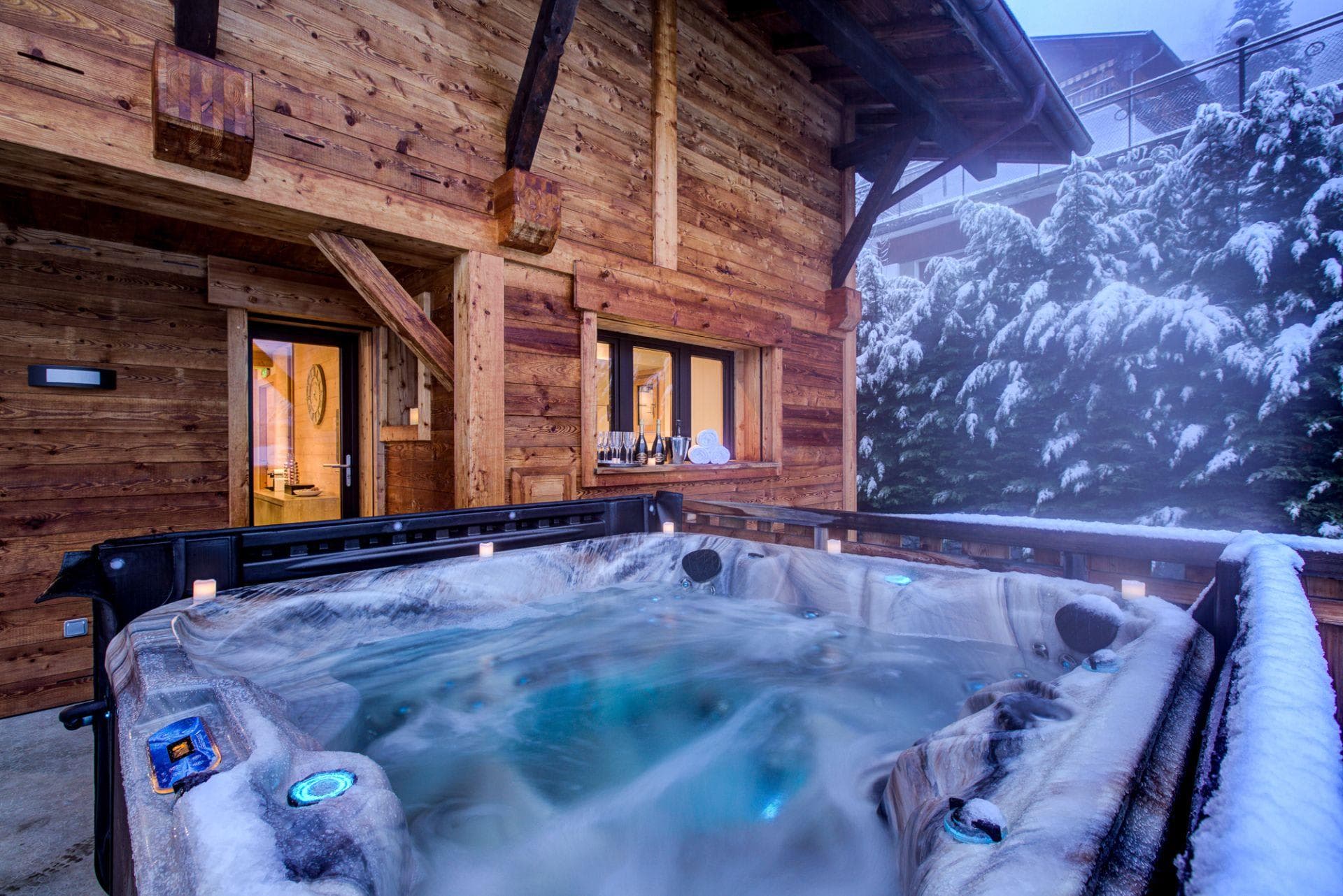 Outdoor hot tub seats 6; snowy mountain backdrop