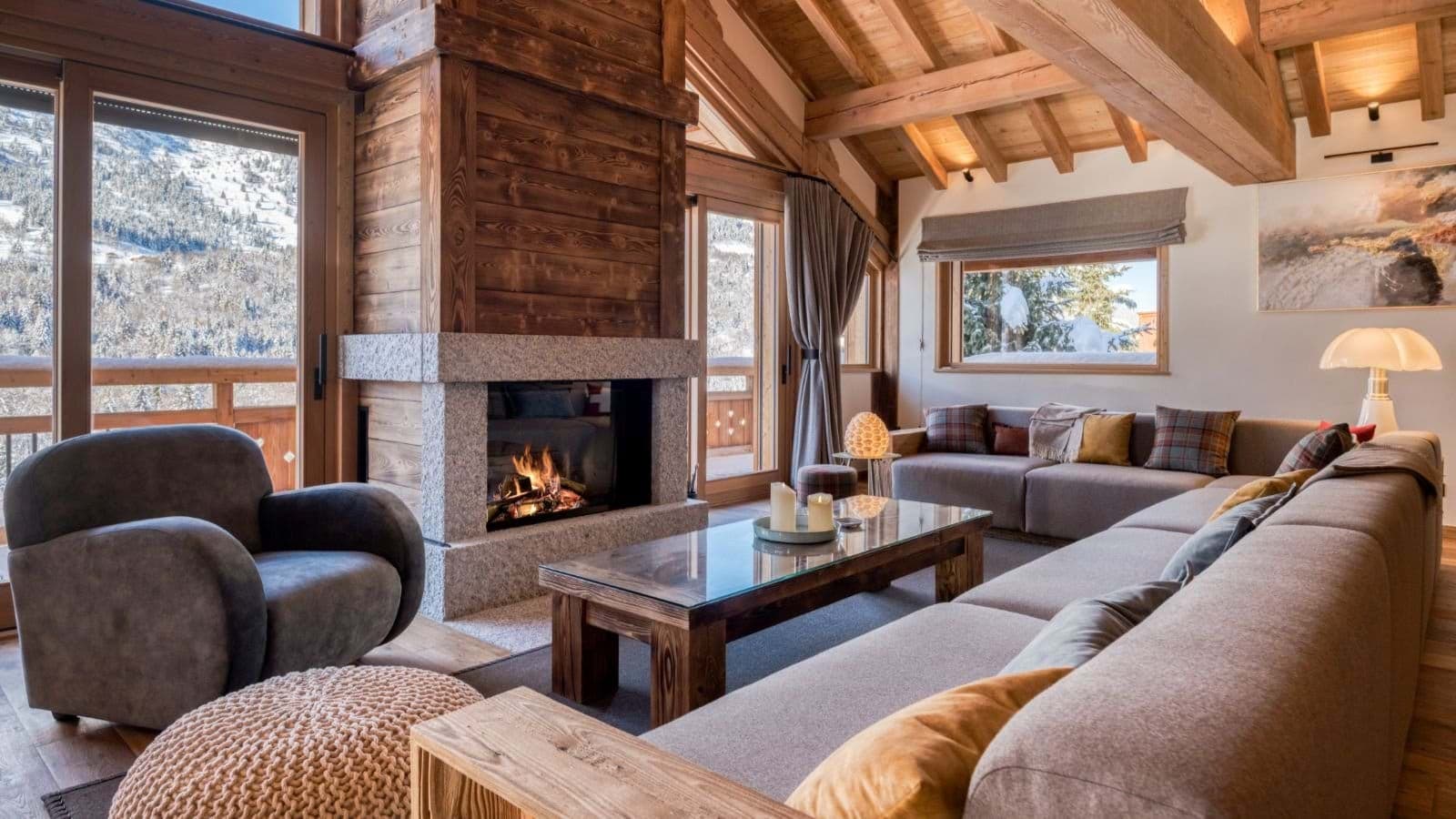 Living room with wood-burning fireplace and vaulted beam ceilings