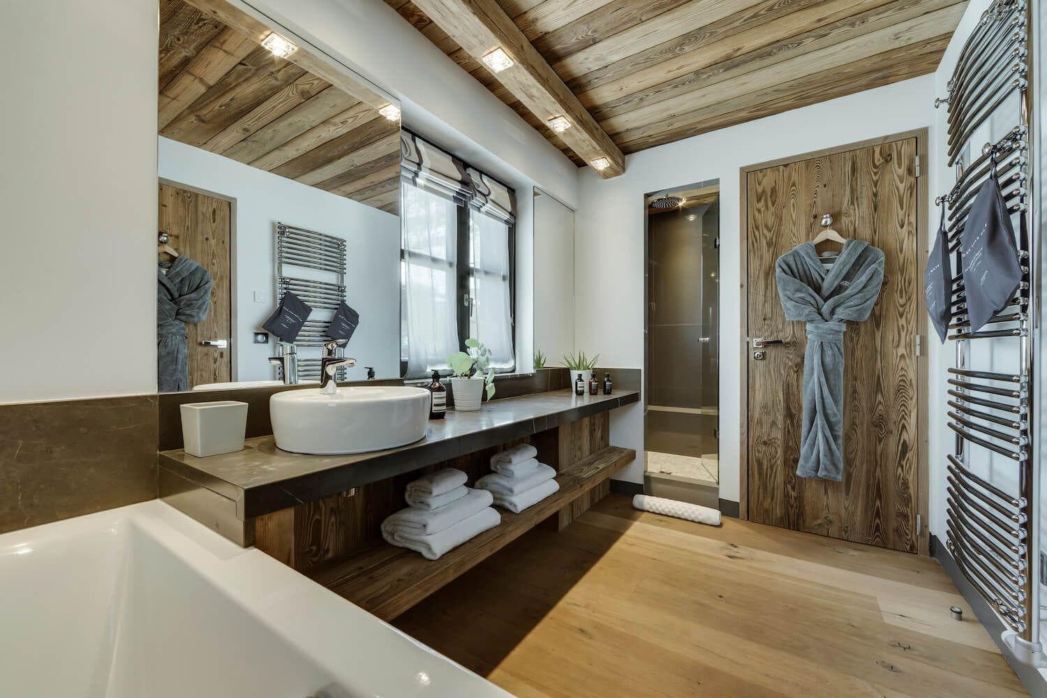 Bathroom with heated towel rails, soaking tub, and walk-in rainfall shower