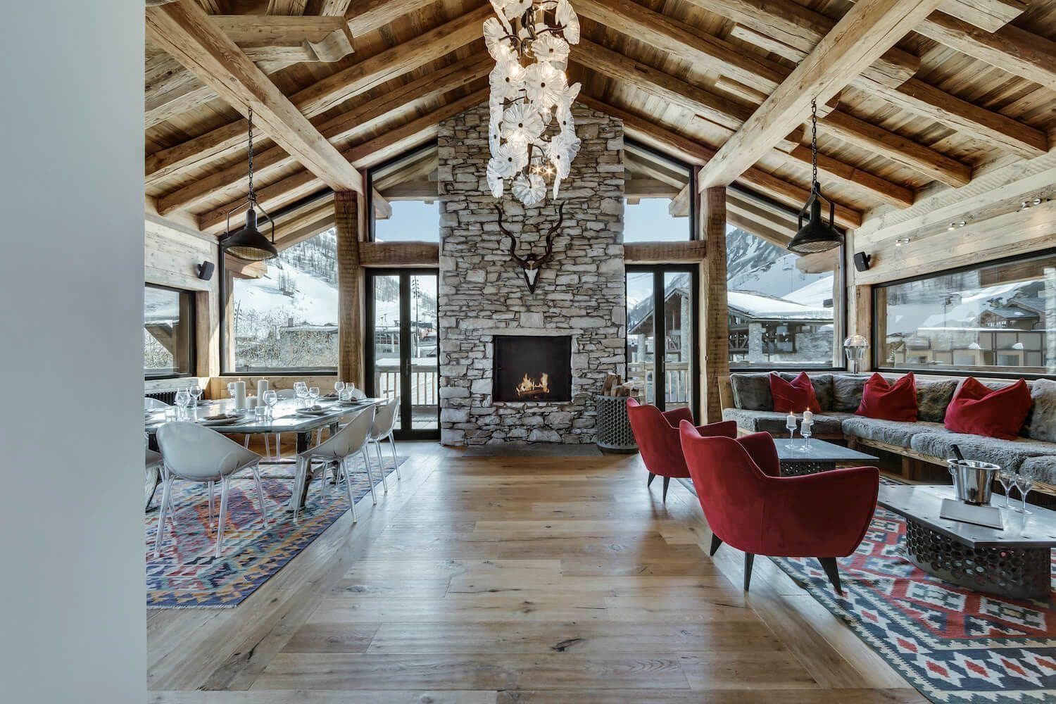 Open living and dining area with stone fireplace and mountain views