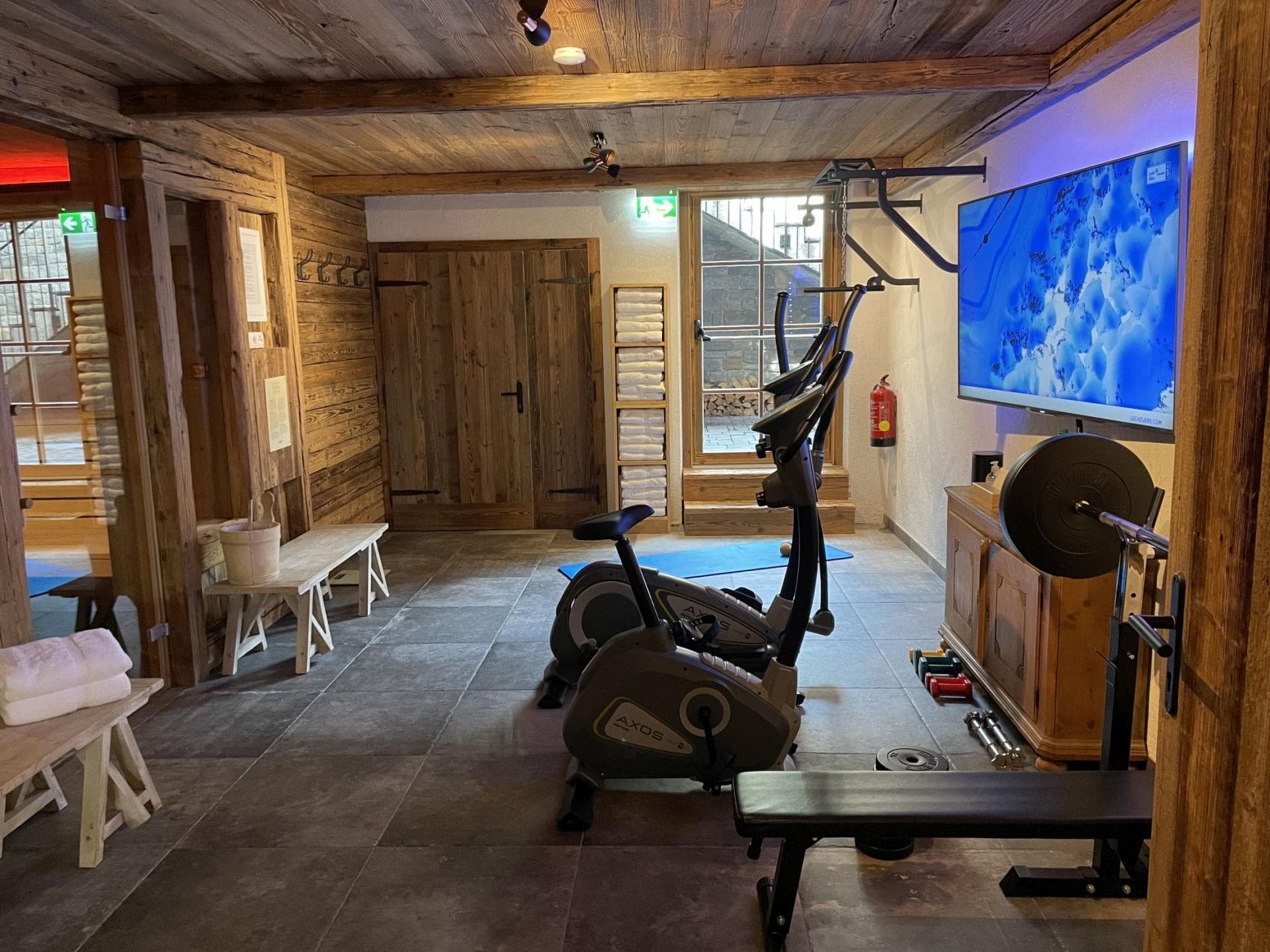 Private gym with stationary bikes, weights, and sauna access