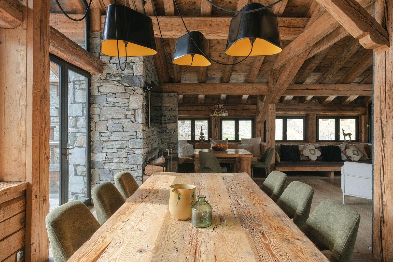 Dining area seats 8; reclaimed wood beams and stone fireplace
