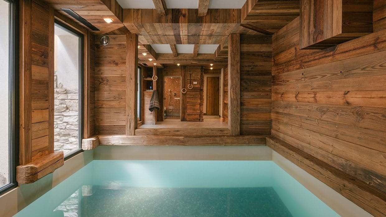 Indoor pool and spa area with reclaimed wood walls and steam shower