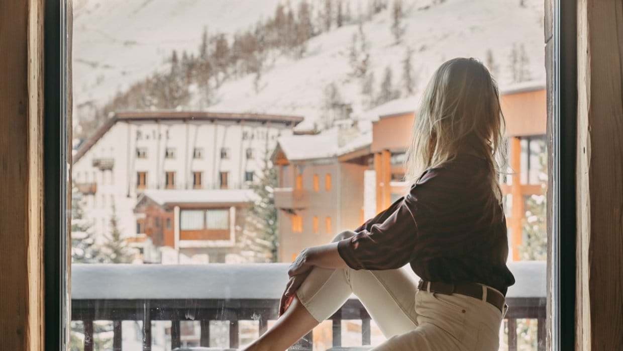 Private balcony view overlooking snow-covered mountains and alpine village