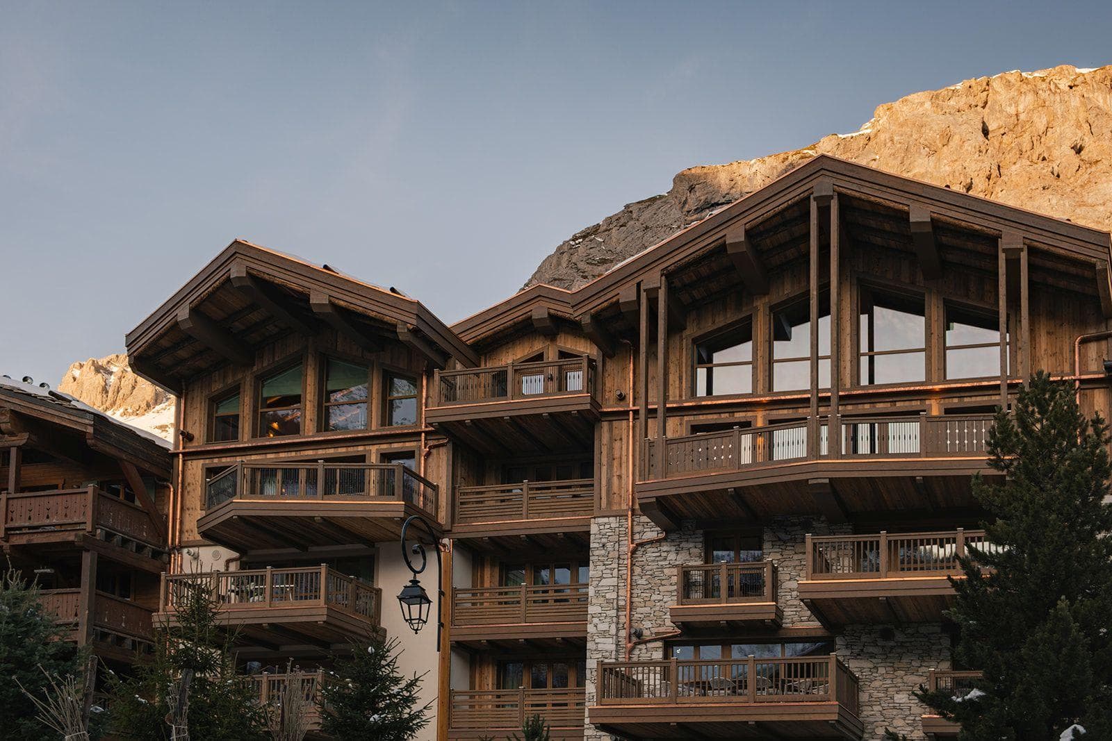 Chalet exterior with multiple private balconies and copper drainage detail
