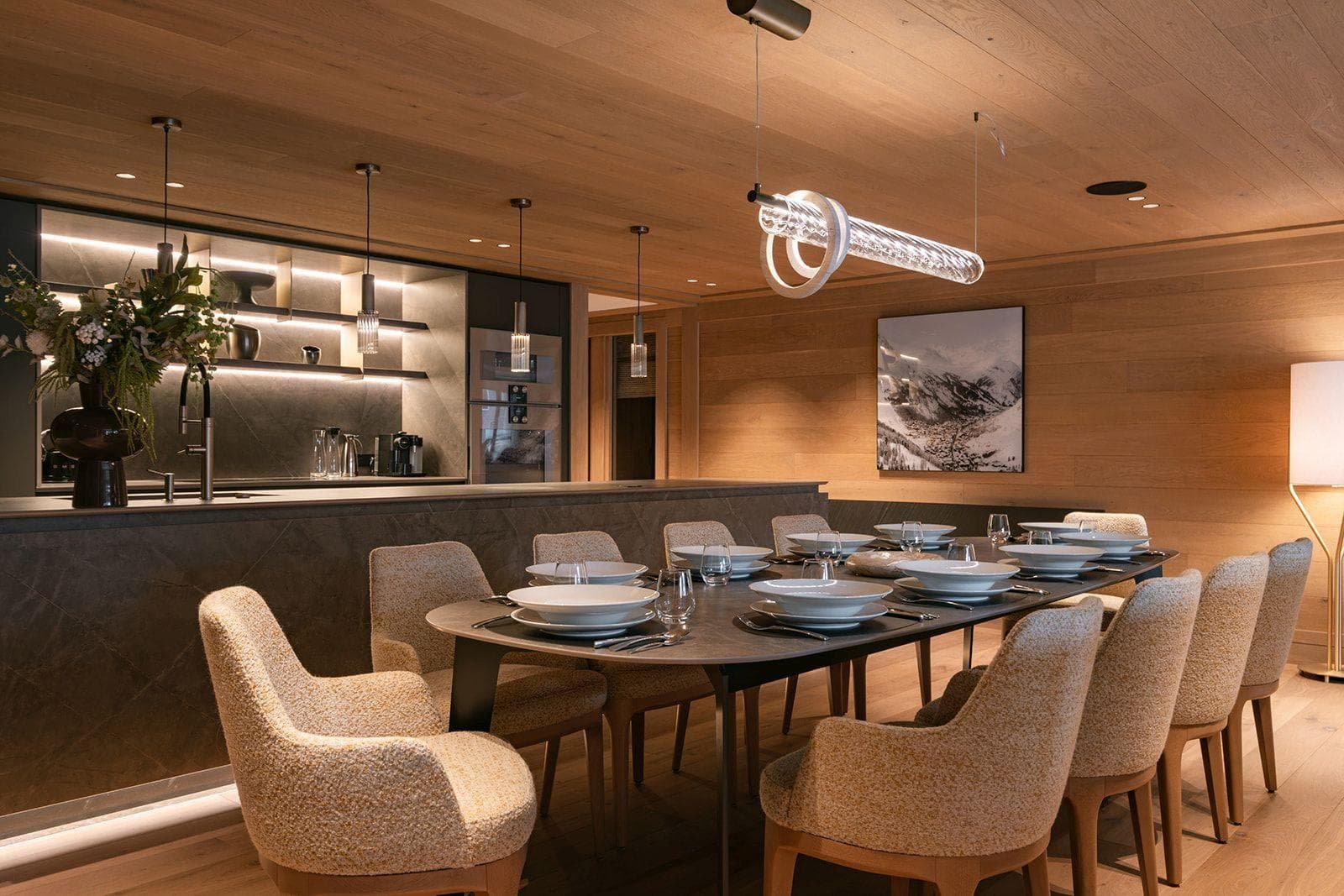 Dining table with seating for 10 adjacent to open-plan kitchen