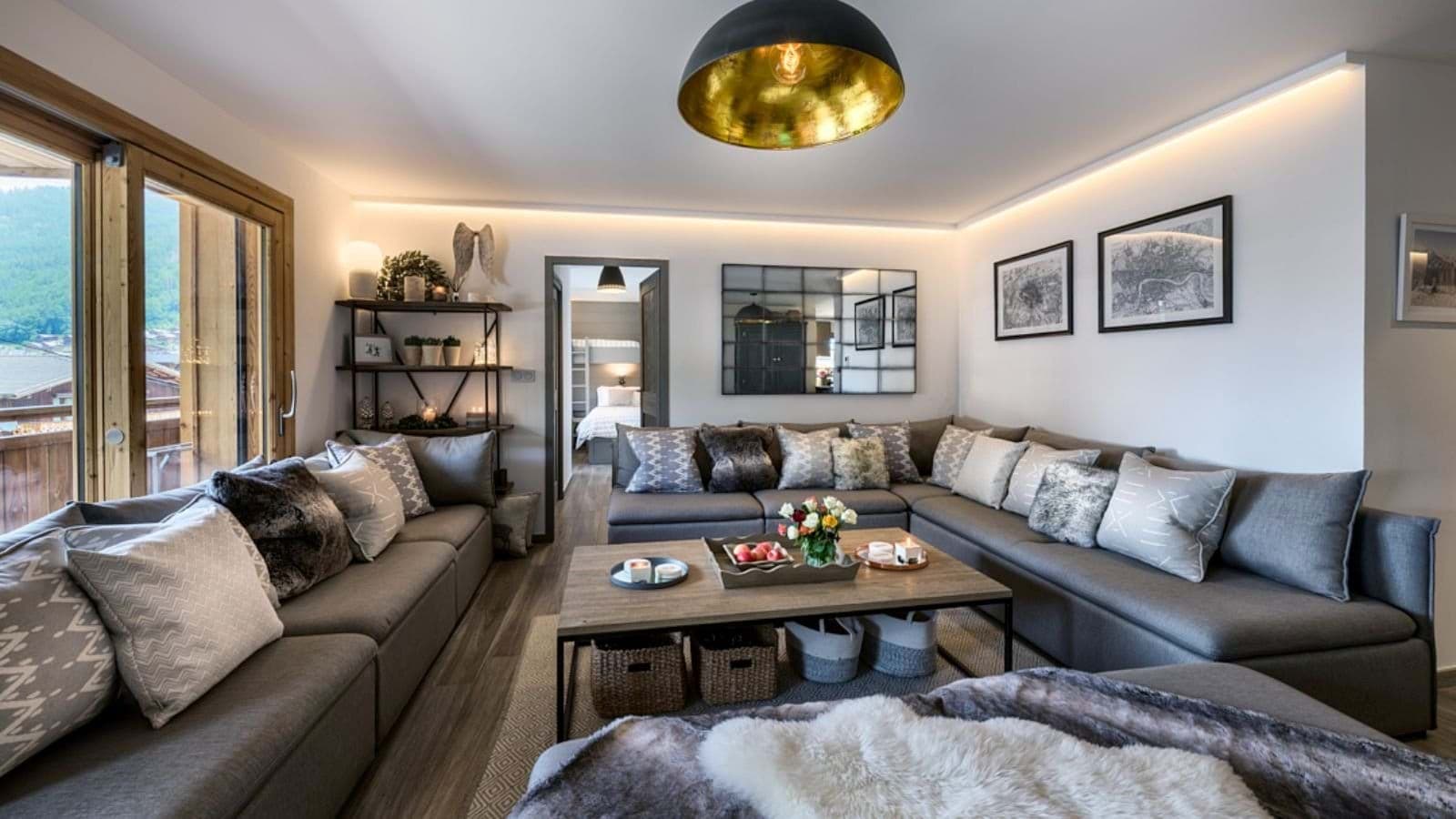 Living room with wraparound sectional seating and mountain views