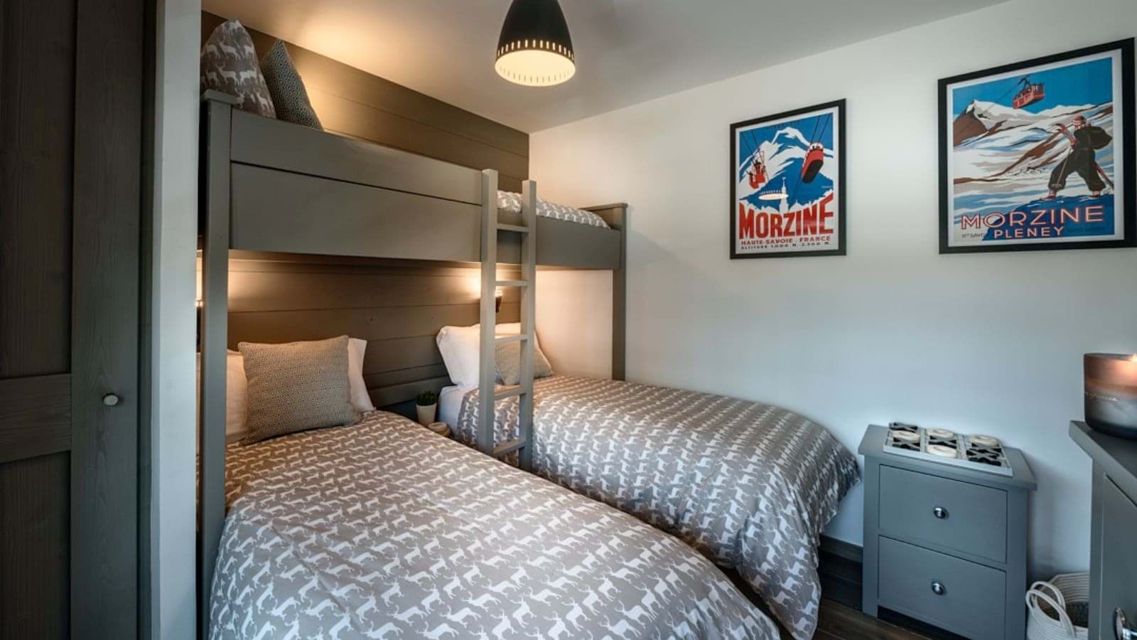 Bunk room with three twin beds and custom built-in frames